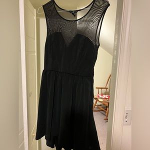 A simple black sheer mesh dress with a side zipper shorter in the front SZ 10